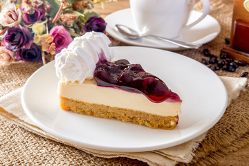 Blue berry cheese cake and coffee on a wooden table