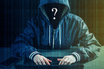 Anonymous hacker programmer uses a laptop to hack the system. Creation and infection of malicious...