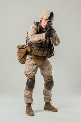 Soldier in camouflage holding rifle