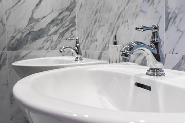 Modern faucet with wash basin sink counter marble wall bathroom interior contemporary