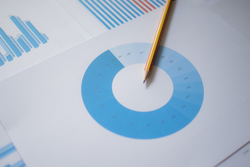Photo diagrams graphs and numerals in the table on the paper