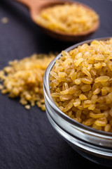 raw bulgur on a dark stone background