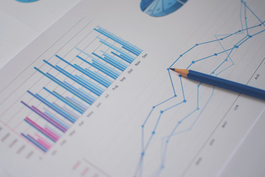 Photo diagrams graphs and numerals in the table on the paper