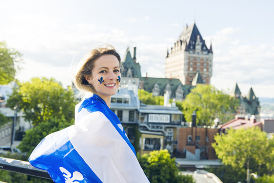 Woman celebrates the national holiday in front of Chateau Frontenac in quebec city