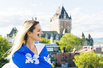 Woman celebrates the national holiday in front of Chateau Frontenac in quebec city