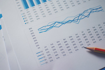 Photo diagrams graphs and numerals in the table on the paper