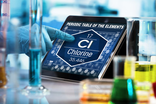 chemist consulting on the digital tablet data of the chemical element Chlorine Cl / researcher working on the computer with the periodic table of elements