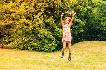 Girl jumping with american flag