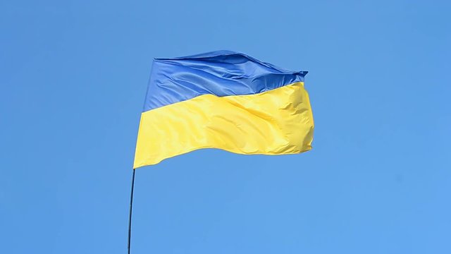 ukrainian flag on the blue sky in windy weather in sunny day, ukraine, europe travel diversity
