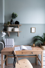 Cozy working space with wooden table ,wooden shelf and artificial plant in the back / Cozy Interior concept /Gold Decoration