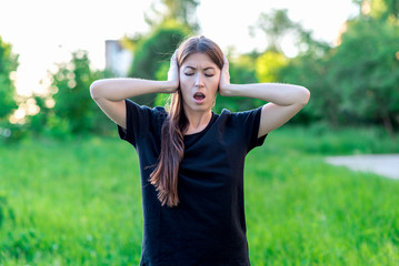 Girl summer in fresh air. I closed my ears with my hands and opened my mouth. Emotions of loud...
