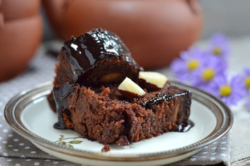 Pieces of chocolate cake with chocolate glaze on a saucer