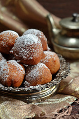 Round sweet curd donuts in a silver bowl on a rustic background