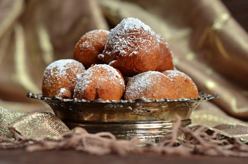 Round sweet curd donuts on a rustic background