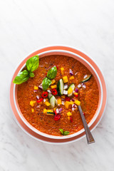 raw fresh refreshing soup of red vegetables and olive oil with onions. healthy food and summer menu