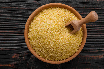 fresh couscous on a wooden rustic background