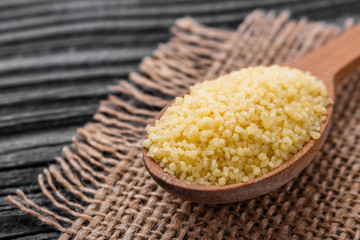 fresh couscous on a wooden rustic background
