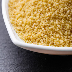 fresh couscous on a dark stone background
