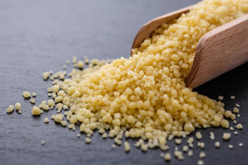 fresh couscous on a dark stone background