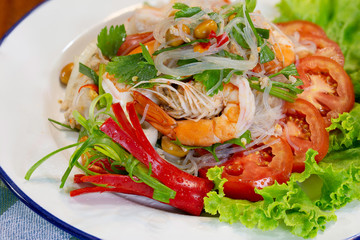 Fresh shrimp spicy salad with vermicelli, thai food delicious in white dish