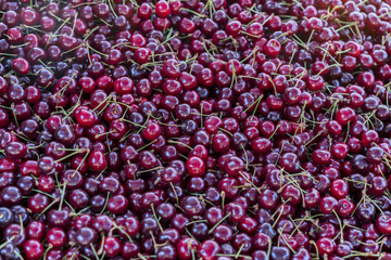 Cherries at a market. Top view of fresh ripe cherries background. Red cherry background
