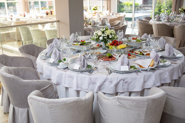 Buffet table of reception with cold snacks, meat, salads and fruits