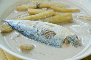 Thai coconut curry of steamed mackerel and lotus stems on bowl