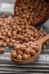 uncooked chickpeas on a wooden rustic background