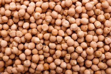 uncooked chickpeas on a white acrylic background