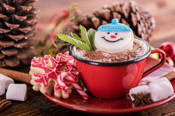 christmas concept snowman cookie in hot cocoa chocolate red mug