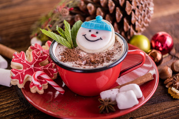 christmas concept snowman cookie in hot cocoa chocolate red mug