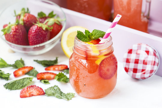 Retro glass jar of detox water with strawberries, lemon and mint