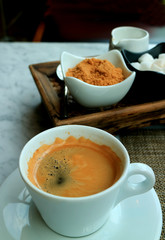 One Cup of Hot Americano Served on the Table with a Coffee Condiment Set