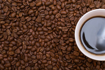 A cup of coffee on a brown background.