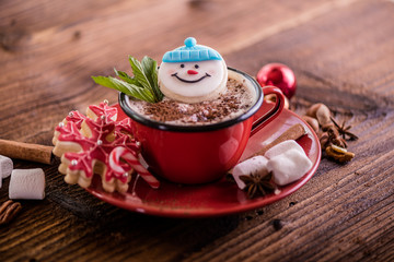 christmas concept snowman cookie in hot cocoa chocolate red mug