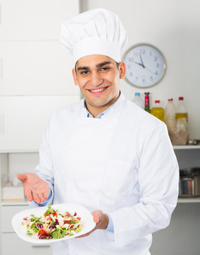 Chef is demonstrating presentation of salad