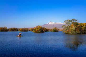 Beautiful view of Mt. Komagatake taken from Onuma park, Hakodate, Hokkaido, Japan. During autumn season with clear blue sky.