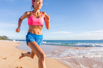 Running fitness runner woman training on beach. Asian girl working out cardio hiit workout. Weight...