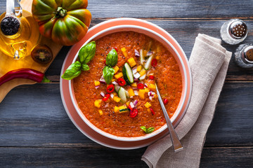 raw fresh refreshing soup of red vegetables and olive oil with onions. healthy food and summer menu
