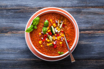 Traditional spanish andalusian tomato cream soup - salmorejo. Salmorejo or gazpacho cream soup on gray bowl