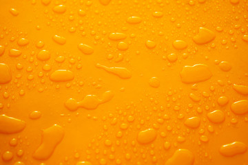 random water drops on flat yellow surface after rain