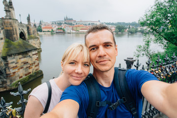 Obraz premium Young happy couple making selfie in the center of Prague.