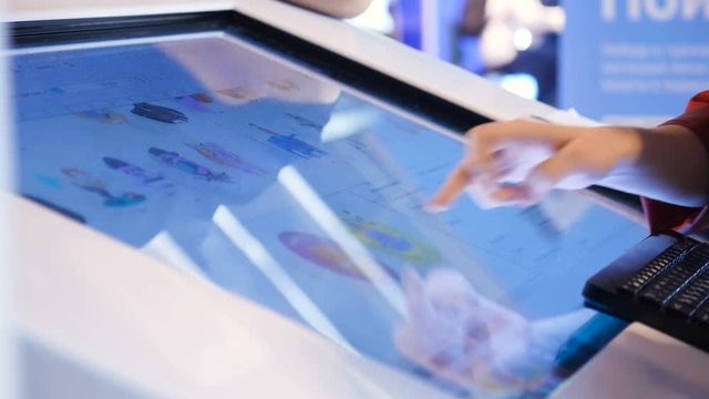 Tech concept. The educator showing functionality of digital gadget closeup in university classroom. Businesswoman use touchscreen at meeting, shows graphical details, progress finance index of economy