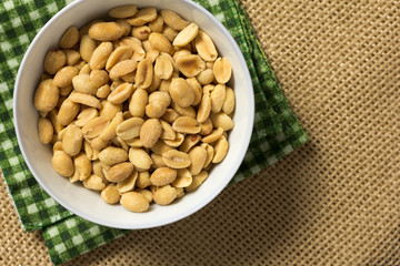 Peanuts. Food of Festa Junina, a typical brazilian party. Snack on plaid fabric and jute.