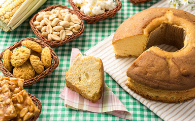 Group of food of Festa Junina, a typical brazilian party: Pe de moleque, peanut, cake, corn, cookies, porcorn. Green Table.