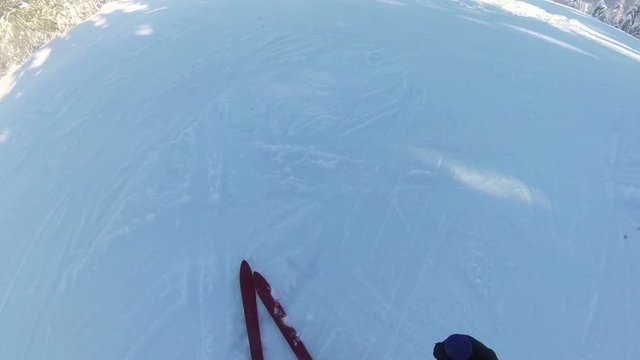 
4K.Man  mountainskier with sticks in  sunny day. Top view
