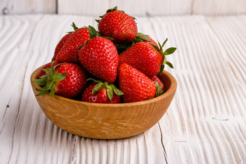 Juicy fresh strawberry on a rustic wooden background
