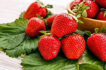 Juicy fresh strawberry on a rustic wooden background