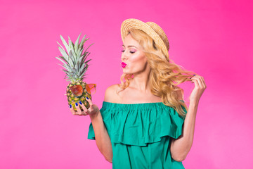 Portrait of happy woman and pineapple over pink background. Summer, diet and healthy lifestyle concept