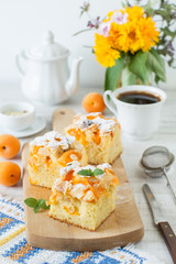 Apricot rustic cake on a table cut in square pieces